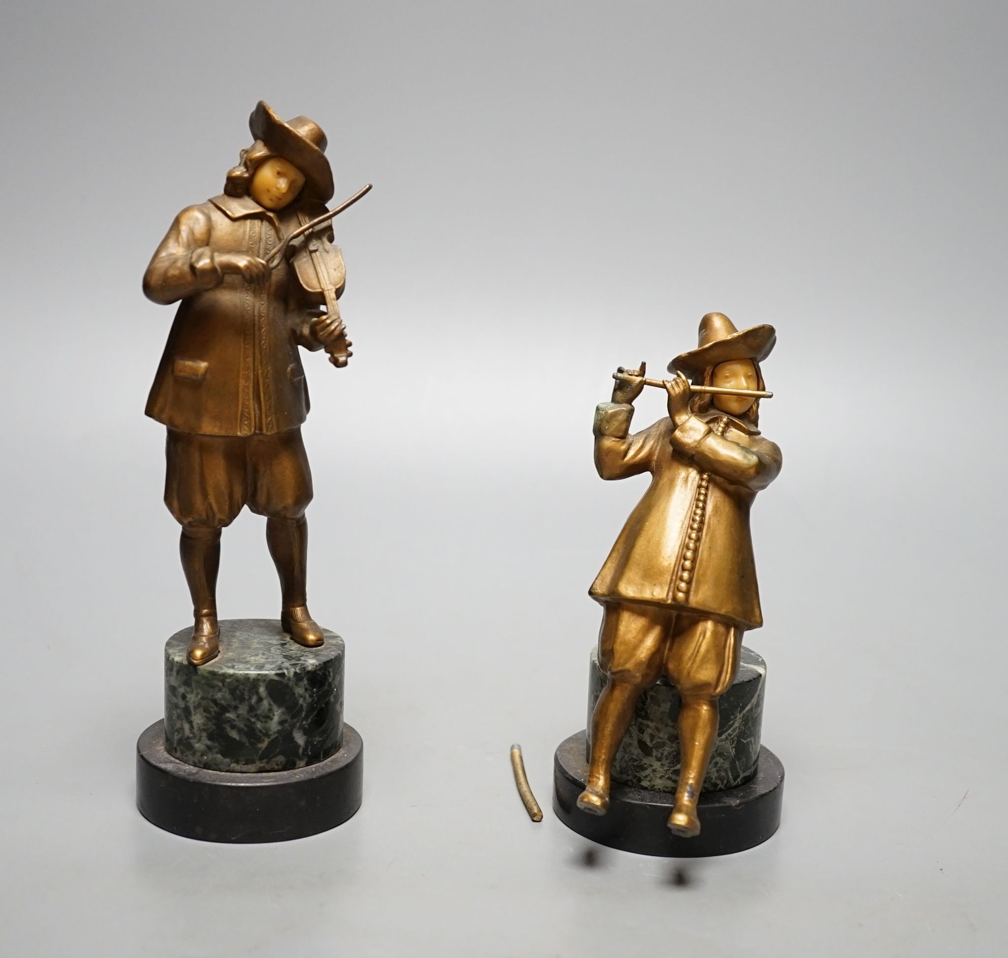A pair of gilt spelter figures of magicians., 19 cms high.